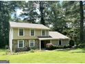 Charming two-story home with a stone facade, inviting curb appeal, and lush landscaping, ready for new owners at 3589 Burlingham Dr, Lithonia, GA 30038