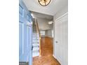 Inviting foyer leading to a spacious living area with hardwood floors and a staircase at 320 Cloverwood Drive, Fayetteville, GA 30215