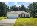 Beautiful home featuring a well-manicured lawn, complemented by a two car garage and brick facade at 315 Antioch Road, Mcdonough, GA 30252