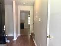 Inviting entryway featuring hardwood floors, neutral paint, and an arched entry to kitchen at 4263 Southvale Dr, Decatur, GA 30034