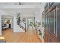 Inviting foyer featuring hardwood floors, high ceilings, and elegant staircase, leading to spacious living areas at 100 Castlebrook Chase, Tyrone, GA 30290