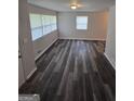 Bright living room featuring stylish gray wood flooring, large windows that let in natural light, and neutral-colored walls at 993 Roosevelt Se Dr, Atlanta, GA 30354