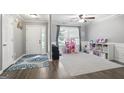 Bright and airy living room with hardwood floors, featuring a ceiling fan and plenty of natural light at 8340 Highway 54, Sharpsburg, GA 30277