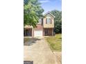 Traditional two-story home featuring brick and siding, attached garage, and well-manicured lawn at 755 Magnolia Gardens Walk, Mcdonough, GA 30253