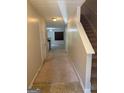 Inviting hallway leading to the kitchen and featuring staircase to the upper level at 755 Magnolia Gardens Walk, Mcdonough, GA 30253