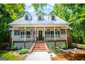 Charming home with brick accents, front porch, and well-maintained landscaping at 301 East Highway 5, Roopville, GA 30170
