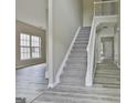 Bright foyer with modern flooring and a staircase leading to the upper level at 1255 Silverstone Trl, Jonesboro, GA 30238