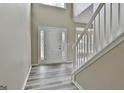 Entryway with modern floors, stairs, and a decorative glass front door at 1255 Silverstone Trl, Jonesboro, GA 30238