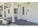 Inviting front porch features classic white columns, tile flooring, and stylish door at 1446 Westmont Sw Rd, Atlanta, GA 30311
