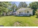 Inviting home boasts a well-manicured lawn and classic white columns on the front porch at 1446 Westmont Sw Rd, Atlanta, GA 30311