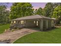 Quaint brick home featuring a convenient carport and well-manicured lawn for comfortable suburban living at 2164 Old Rex Morrow Rd, Morrow, GA 30260