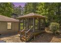 Enclosed gazebo adjacent to brick house and green lawn offering a private outdoor space at 2164 Old Rex Morrow Rd, Morrow, GA 30260