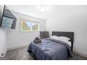 Cozy bedroom featuring a comfortable bed, soft carpet, a TV and natural light from the window at 3859 N Camp Creek Sw Pkwy, Atlanta, GA 30331