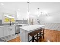 Beautiful kitchen with quartz countertops, herringbone backsplash, stainless steel appliances, and stylish pendant lighting at 3859 N Camp Creek Sw Pkwy, Atlanta, GA 30331
