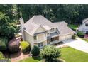 Aerial view of this two-story home showing the roof, manicured lawn, and mature trees at 148 Lakeside Dr, Peachtree City, GA 30269