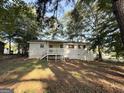 This home features a spacious, tree-shaded backyard with deck, offering a peaceful outdoor retreat at 10103 Allen Sw Dr, Covington, GA 30014
