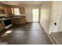 A traditional kitchen with wood cabinets and dated appliances and damaged flooring needs renovation at 10103 Allen Sw Dr, Covington, GA 30014