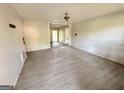 A spacious living room with a ceiling fan and damaged flooring is waiting for renovation at 10103 Allen Sw Dr, Covington, GA 30014