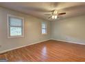 Light-filled bedroom features hardwood floors and two windows that offer plenty of natural light at 3681 Chestnut Lake Ct, Jonesboro, GA 30236