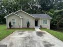 Charming single-story home with a well-maintained front yard and a concrete driveway at 9107 Morris Sw Dr, Covington, GA 30014