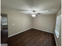 Spacious living room features hardwood floors, a ceiling fan, and plenty of natural light at 9107 Morris Sw Dr, Covington, GA 30014