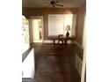 A dining room area with wood floors, a ceiling fan and table at 301 Wedowee St, Bowdon, GA 30108