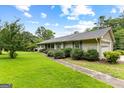 Charming single-story home featuring an attached garage and a well-manicured lawn at 110 Mourning Dove S Dr, Fayetteville, GA 30215