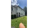 A view of the side of the home showing neutral siding, green grass and an access door on the side of the house at 5753 Barrington Run # 114, Union City, GA 30291