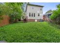 Spacious backyard featuring a lush lawn and mature trees, offering plenty of room for outdoor activities at 1484 Mcpherson Se Ave, Atlanta, GA 30316