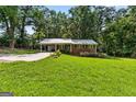 Charming one-story brick home with a metal roof and spacious front lawn at 1833 S Highway 92, Fayetteville, GA 30215