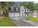 Charming two-story home with a covered front porch, attached two-car garage and a spacious driveway at 539 Riverbirch Trce, Stone Mountain, GA 30087