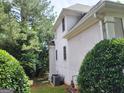 Side of house with a stucco exterior, complemented by lush greenery and well-maintained landscaping at 2911 Chesterfield Se Way, Conyers, GA 30013