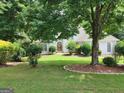 Beautiful exterior of a well-maintained home with a lush green lawn and mature trees, creating a serene setting at 2911 Chesterfield Se Way, Conyers, GA 30013