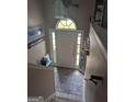 Welcoming entryway with a decorative rug and arched window above the front door at 1524 Queen Elizabeth Dr, Locust Grove, GA 30248