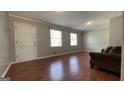 Spacious living room with hardwood floors, neutral paint, and plenty of natural light at 8436 Magnolia Dr, Jonesboro, GA 30238
