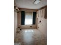 Bright laundry room with tile floor and white cabinets ready for appliances at 177 Northwind Sw Ct, Lilburn, GA 30047