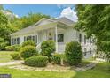 Lovely one-story home with inviting front porch and meticulously maintained shrubs at 1493 Vesta Ave, Atlanta, GA 30337