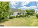 Well-maintained home with tidy landscaping and a welcoming covered front porch at 1493 Vesta Ave, Atlanta, GA 30337