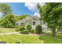 Quaint one-story home featuring a covered front porch and well-manicured landscaping at 1493 Vesta Ave, Atlanta, GA 30337