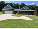 Beautiful single-story home with a large driveway, attached garage, and inviting front porch at 195 Twin Oaks Dr, Hampton, GA 30228