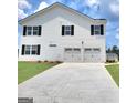 This gorgeous home features a two car garage and large driveway perfect for multiple car parking at 363 Friendship Oak Way, Hampton, GA 30228