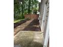 Side yard with mulch beds, a stone path, and a view of the backyard fence at 4887 Winterview Ln, Douglasville, GA 30135