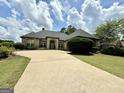 Charming single-story home features a well-maintained front yard, a long driveway, and a welcoming entrance at 6409 Caledon Ct, Locust Grove, GA 30248