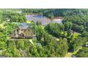 Scenic aerial view of home, lake, and surrounding lush greenery at 551 Lees Mill Rd, Fayetteville, GA 30214