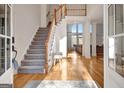 Bright and airy foyer with hardwood floors, staircase, and soaring ceilings at 551 Lees Mill Rd, Fayetteville, GA 30214
