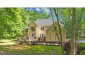 Charming two-story home features a manicured lawn and front garden at 551 Lees Mill Rd, Fayetteville, GA 30214