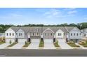 Aerial view of new townhomes, each featuring a two-car garage and modern exteriors at 332 Sinclair Ct # 77, Mcdonough, GA 30253