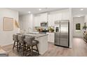Modern kitchen with white cabinets, stainless steel appliances, and a granite island at 332 Sinclair Ct # 77, Mcdonough, GA 30253