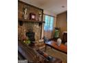 Inviting living room with stone fireplace, wooden mantel, and view of leather sofa at 259 Independence Dr, Jonesboro, GA 30238