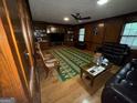 Spacious living room with hardwood floors, wood paneling, and ample natural light at 4355 Hambrick Pl, Stone Mountain, GA 30083